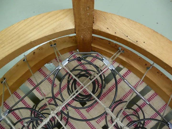 Springs, tied by hand, on a 1920s parlor chair in the shop